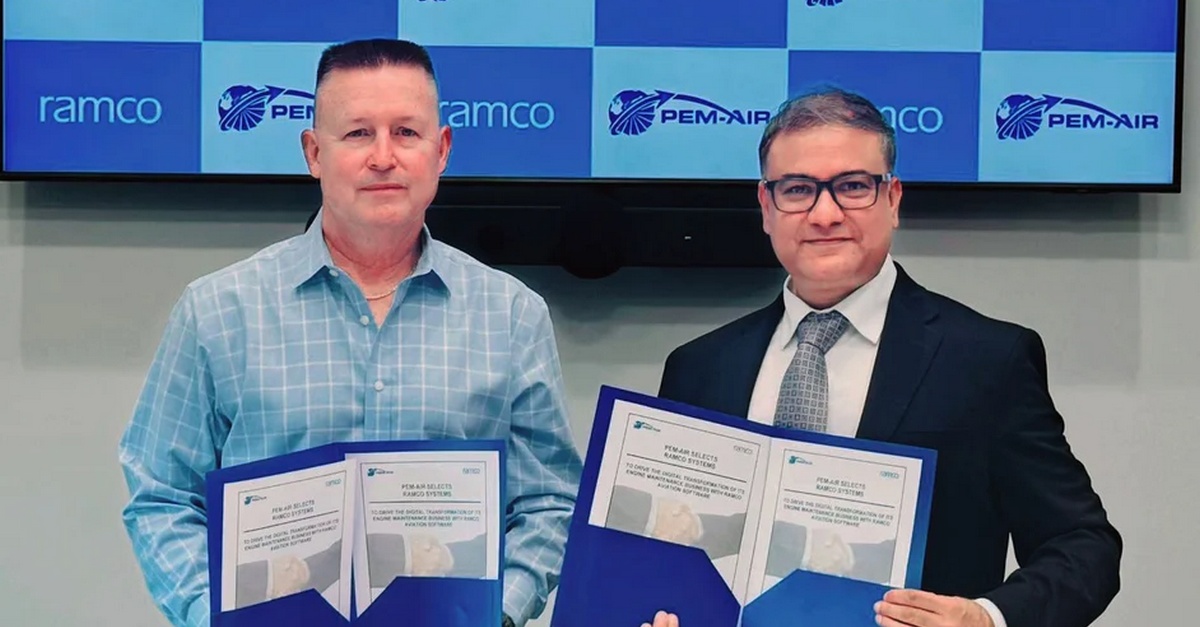 Two men standing side during a partnership signing ceremony